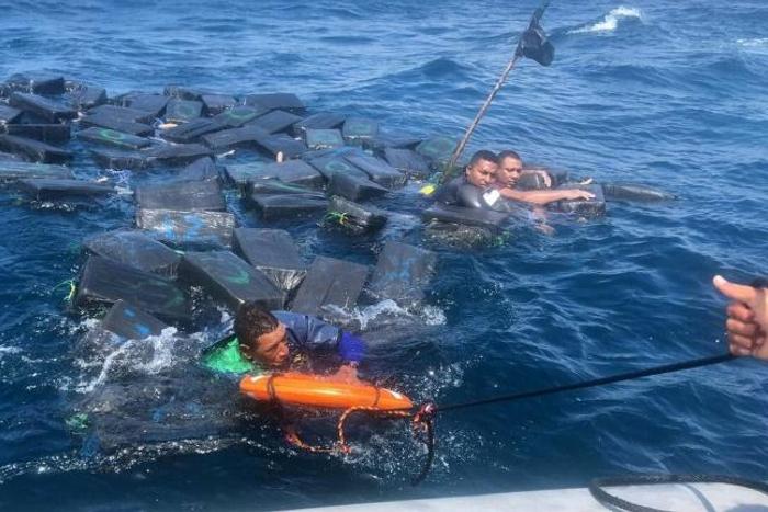 A photo released by the Colombian Navy on October 1, 2019 shows the rescue of three men floating on bales of cocaine off the Pacific coast