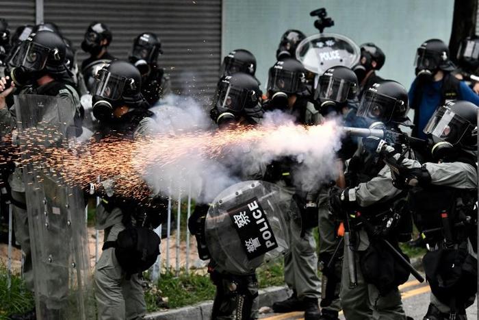 Riot police used tear gas throughout the afternoon and evening in Yuen Long after tense standoffs with protesters, some of whom were throwing projectiles and had surrounded a police van