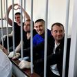 In the cramped courtroom, the sailors, who have described themselves as 'prisoners of war', were held in a metal-barred cage reserved for defendants