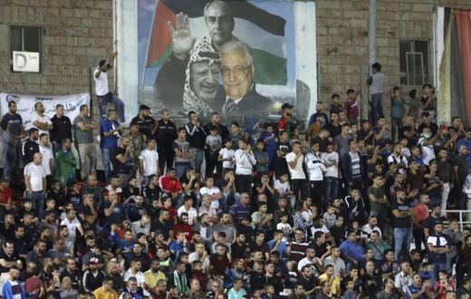 Spectators watch a match between Palestinian team Hilal al-Quds and Morocco's Raja Casablanca -- the first Moroccan football team to play in the occupied Palestinian territories on October 3, 2019