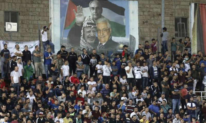 Spectators watch a match between Palestinian team Hilal al-Quds and Morocco's Raja Casablanca -- the first Moroccan football team to play in the occupied Palestinian territories on October 3, 2019