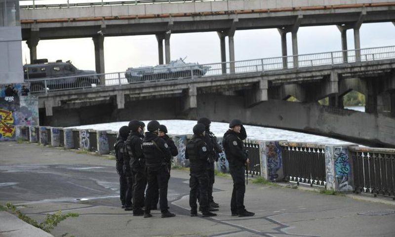 A large number of police cars and armed personnel carriers were at the scene, while special forces and snipers guarded the bridge after the man used his vehicle to block the bridge across the Dnipro river