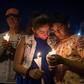 People hold candles as they pray during a candlelight vigil at the Immanuel Church for victims of a shooting that left a total of 22 people dead at the Cielo Vista Mall WalMart in El Paso, Texas, on August 5, 2019