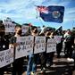Supporters of the Hong Kong pro-democracy protesters hold placards during a demonstration as part of the global "anti-totalitarianism" movement in Sydney