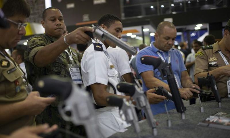 Visitors inspect guns during a security and defense expo in Rio de Janeiro, Brazil, on April 02, 2019