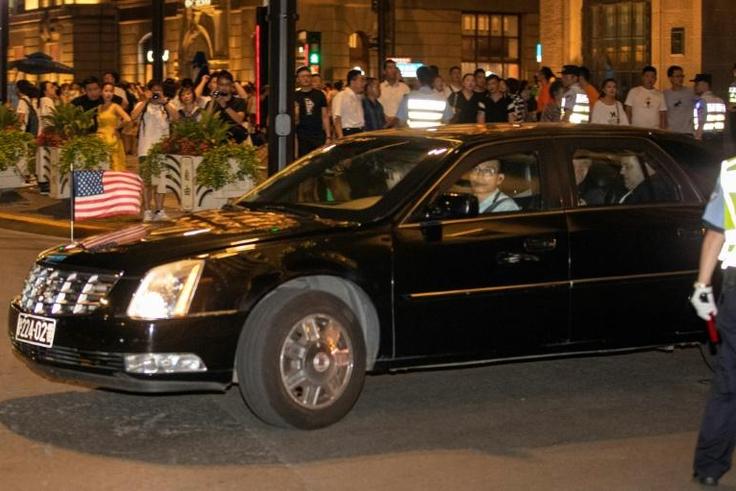 A consulate car carrying members of the US trade delegation leaves the Peace Hotel in Shanghai