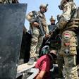 Iraq's rapid response forces detain a man as they storm a house north of Baghdad searching for wanted Islamic State group suspects on July 21, 2019