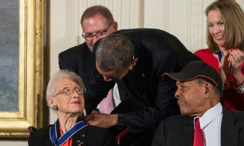 Katherine Johnson, seen here receiving the Presidential Medal of Freedom from Barack Obama, provided pivotal contributions to American space flight research alongside Dorothy Vaughan and Mary Jackson