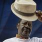 Special AU envoy Raila Odinga gives his trademark salute for the dead for 8 pupils who died at Precious Talents School