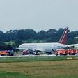 Firecrews attend an Omni Air International aircraft on the tarmac at Shannon Airport in County Clare, western Ireland, after a fire broke out on the undercarriage of the plane on the runway