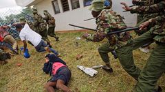 Supporters of President Uhuru Kenyatta engage in rock-throwing clashes with police at his inauguration ceremony after trying to storm through gates to get in and being tear-gassed, at Kasarani stadium in Nairobi, Kenya.