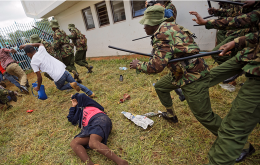 Supporters of President Uhuru Kenyatta engage in rock-throwing clashes with police at his inauguration ceremony after trying to storm through gates to get in and being tear-gassed, at Kasarani stadium in Nairobi, Kenya.