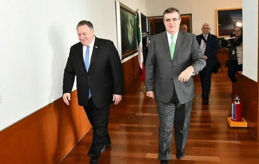 Mexico's Foreign Secretary Marcelo Ebrard (R) walks with US Secretary of State Mike Pompeo before a meeting in Mexico City that focused on slowing northward migration