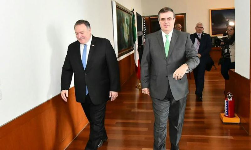Mexico's Foreign Secretary Marcelo Ebrard (R) walks with US Secretary of State Mike Pompeo before a meeting in Mexico City that focused on slowing northward migration