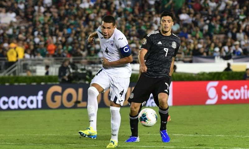 Cuba's Yasmani Lopez (L) vies for the ball with Mexico's forward Raul Jimenez (R) during their Concacaf Gold Cup match in California -- after which Lopez defected