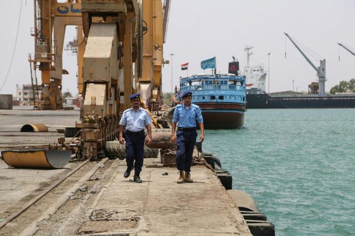 Yemeni coast guards walk at Saleef port in the western Red Sea Hodeida province after their redeployment following the withdrawal of Huthi rebel fighters, on May 13, 2019