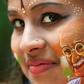 Britain will commission a commemorative coin to mark the 90th anniversary of the final visit by Indian independence hero Mahatma Gandhi; a girl poses for a picture, August 15, 2019, with her face painted depicting a portrait of Mahatma Gandhi
