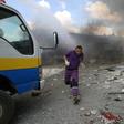 A rescuer from the Violet NGO runs during airstrikes by Syrian regime forces in Maar Shurin on the outskirts of Maarat al-Numan in northwest Syria on July 16, 2019