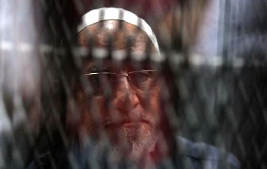Egyptian Muslim Brotherhood Supreme Guide Mohamed Badie is seen behind bars during a hearing for him and other Brotherhood members on charges of espionage, as the country's crackdown on the Islamist group continues