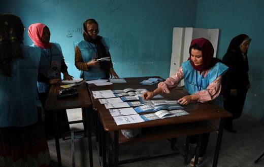 Afghan Independent Election Commission (IEC) officials count ballot papers after polling station closed in Mazar-i- Sharif