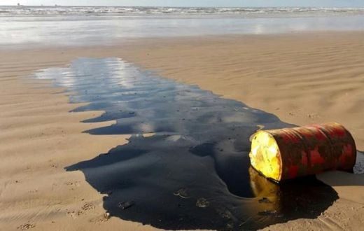 A barrel of oil leaking on a beach in Barra dos Coqueiros, in the Braziilian state of Sergipe