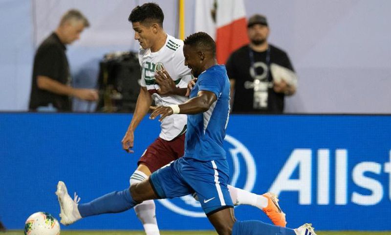 Mexico's Uriel Antuna (L) vies for the ball with Martinique's Samuel Camille (R) during their CONCACAF Gold Cup Group A match in Charlotte, North Carolina