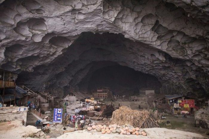 Zhongdong village, where a group of 18 families live inside an enormous natural cave with all the modern conveniences, like electricity