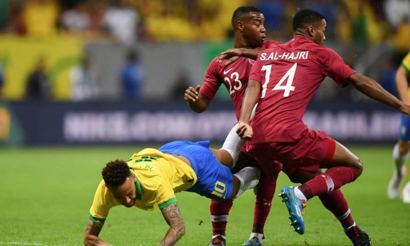 Brazil's Neymar (L), Qatar's Assim Madebo (C) and Qatar's Salem Alhajri vie for the ball during a friendly football match in Brasilia ahead of Brazil 2019 Copa America