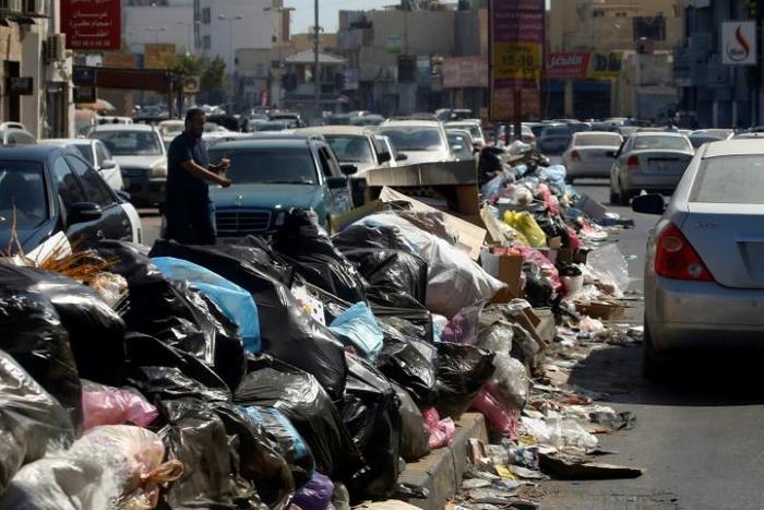 Across Libya's capitol Tripoli, tonnes of waste overflows from bins and piles up on roadsides