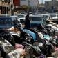 Across Libya's capitol Tripoli, tonnes of waste overflows from bins and piles up on roadsides