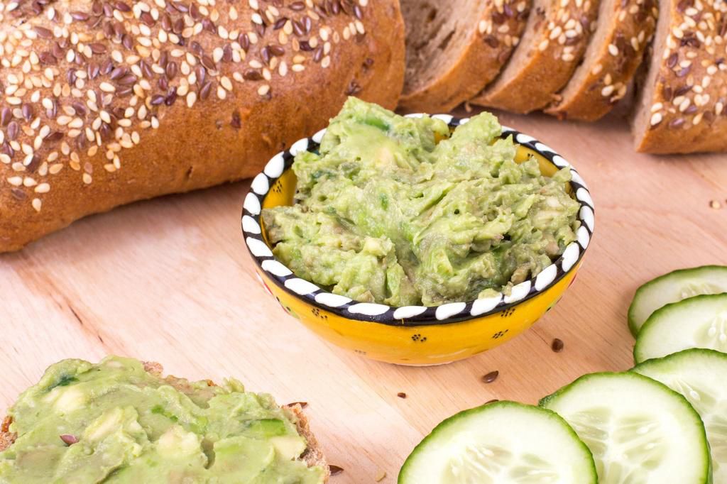 Cucumber and avocado sandwiches on bread background.