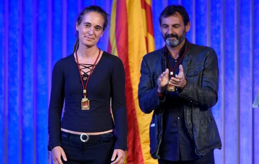 Migrant rescue ship captain Carola Rackete is given a medal from Catalonia's regional parliament alongside Proactiva Open Arms founder Oscar Camps