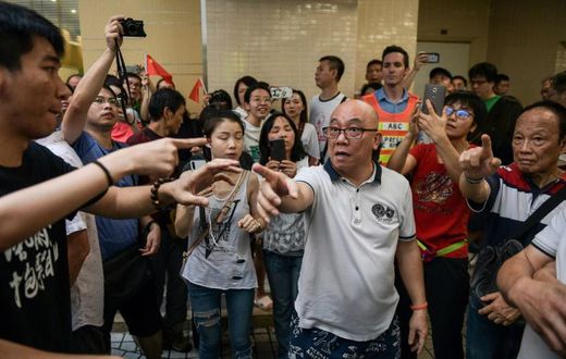 A group of men, many waving Chinese flags, attacked people perceived to be pro-democracy protesters