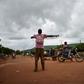 A Malian activist directs traffic on August 27, with the main road between the capital of Bamako and the western city of Kayes closed due to protest