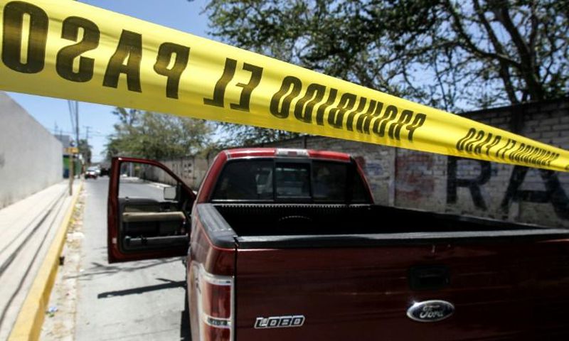 Police guard the site where forensic investigators have exhumed bodies from a mass grave in a farm in Zapopan, in Mexico's Jalisco state