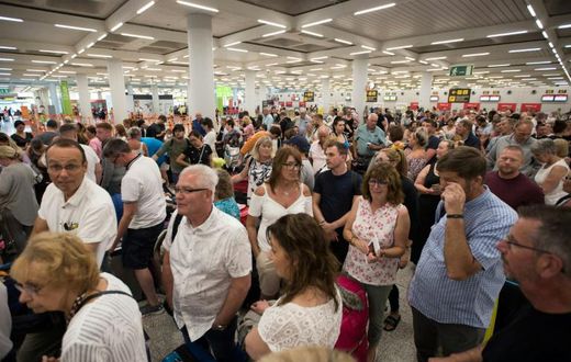 Passengers of British travel group Thomas Cook queue at Son Sant Joan airport in Palma de Majorca, Spain