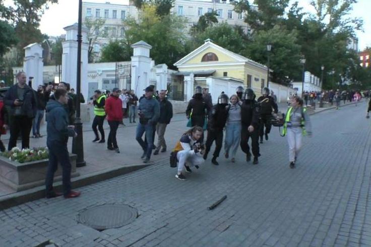 The video, which has more than 360,000 views, shows a young woman dragged by four masked policemen in riot gear, with one of them punching her in the stomach for no apparent reason  