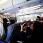 Pope Francis (2ndL) is flanked by his spokesperson Matteo Bruni (3rdL) and the Pope's trip organizer Father Mauricio Rueda, during his flight from Antamanarivo to Rome, on September 10, 2019, after his seven-day pastoral trip to countries in Africa