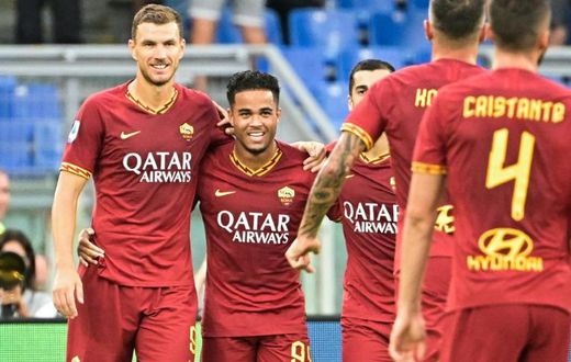 AS Roma's Dutch forward Justin Kluivert (2ndL) celebrates with Bosnian Edin Dzeko (L) after scoring his team's fourth goal against Sassuolo.