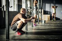 Men and women warming up for training in gymnasium