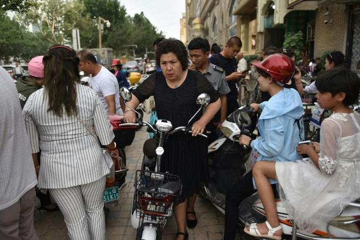 UN ambassadors from 37 countries have released a letter defending China's treatment of Uighur and other minorities in the Xinjiang region, in direct response to Western criticism This photo taken on June 4, 2019 shows a Uighur woman pushing an electric...