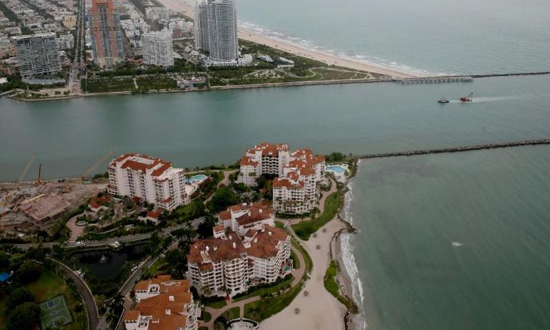Fisher Island (bottom) in Miami was the home of convicted swindler Anthony Gignac who duped investors by posing as Saudi Prince Khalid Bin Al-Saud