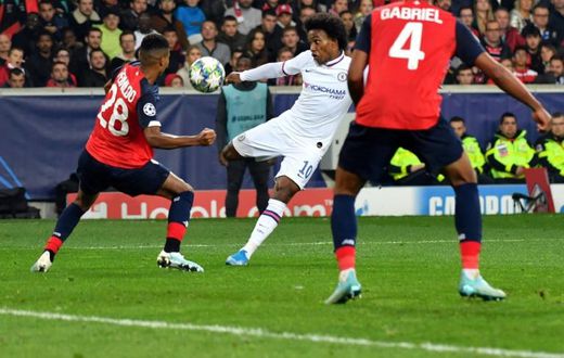 Willian (in white) volleys in Chelsea's winning goal