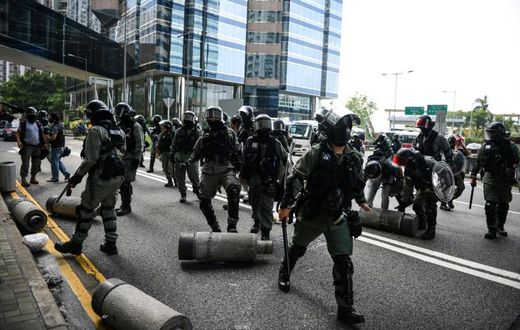 Police clear barricades left by protestors. Clashes between police and activists were less intense than at the start of October when the city was virtually shut down