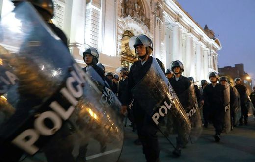 Riot police move into position around the Congress building in Lima after President Martin Vizcarra announced he was dissolving the opposition-dominated legislature