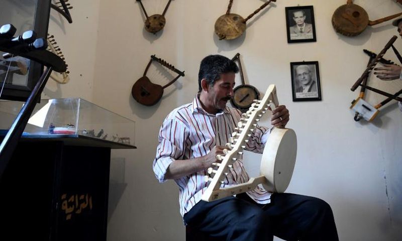 Egyptian craftsman Mohamed Ghaly adds the finishing touches on a semsemia that he made at the Canal 20 cultural museum in Port Said which he founded to pass on the musical heritage to a new generation