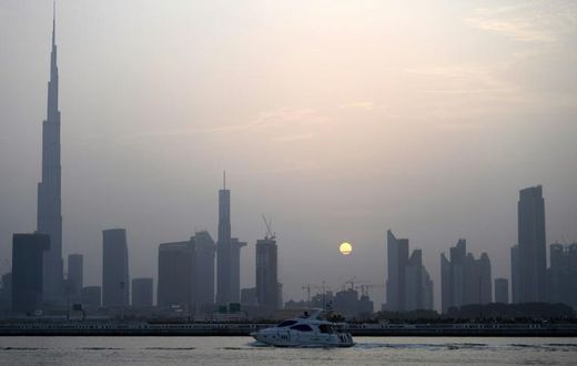 With the highest building in the world, Burj Khalifa (left), grand commercial centres and artificial islands, Dubai projects an image of prosperity