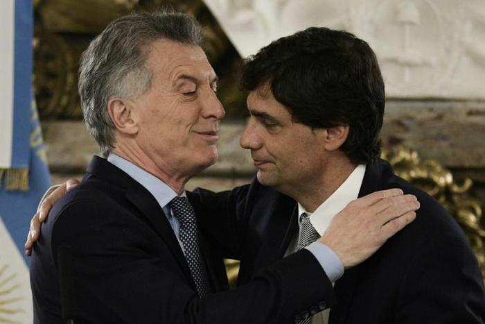 Argentina's President Mauricio Macri (L) congratulating his new finance minister Hernan Lacunza, who now faces the task of stabilizing Argentina's currency