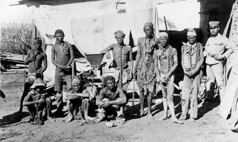A colonial soldier (R) in German South West Africa (now Namibia) keeps a watchful eye over prisoners taken during the 1904-1908 war against the Herero and Nama people