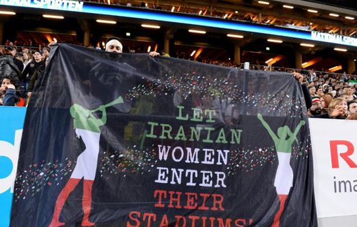 Supporters hold a banner calling for Iranian women to be allowed to enter football stadiums, during a match between Sweden and Iran near Stockholm in March 2015